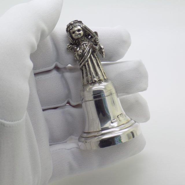 An elegant vintage object depicting a bell with an angel conductor, handcrafted in Florence (Tuscany) between the 1980s...