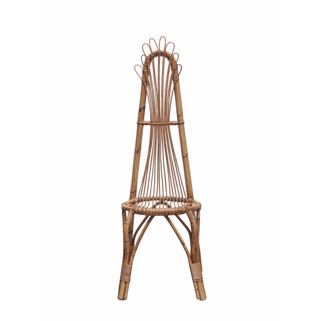 Rattan and bamboo chair that adds warmth and charm to any home. This chair has a high woven rattan backrest and a sturdy...