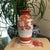 Japanese Kutani hand painted porcelain vase. Painted in earth tone reds, very pale sky blue and touches of ink black....