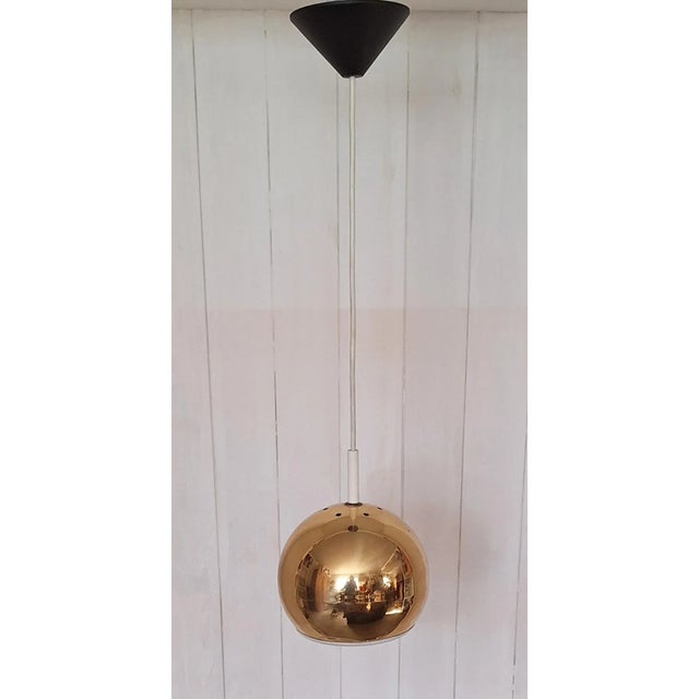 Vintage Ceiling Lamp with Spherical Gold-Colored Metal Shade and White Reflector, 1970s, in Good conditions. Designed 1970...