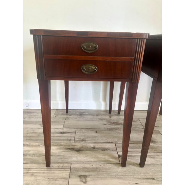 Beautiful pair of vintage mahogany Hepplewhite end tables. Exceptional build quality with mahogany wood and veneer....