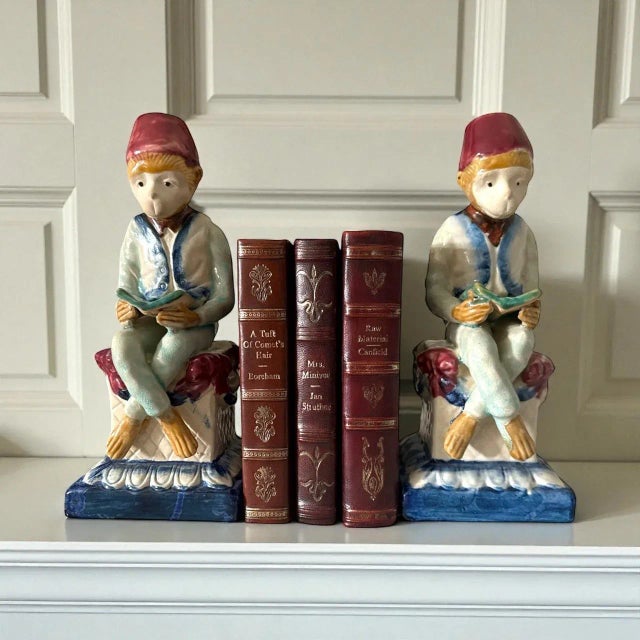 A captivating and highly decorative pair of vintage European majolica figures, circa 1930s, depicting two seated monkeys...