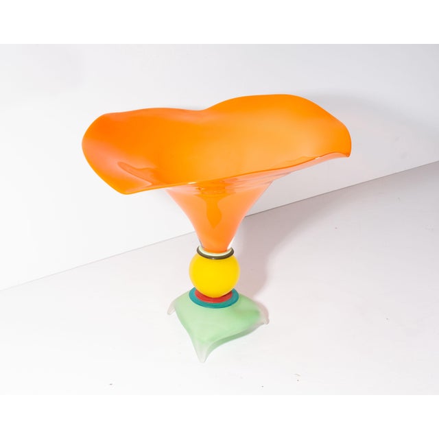 A 2005 art glass vase by the American glass artist Stephan Cox (born 1956). This whimsical work features a bright orange...
