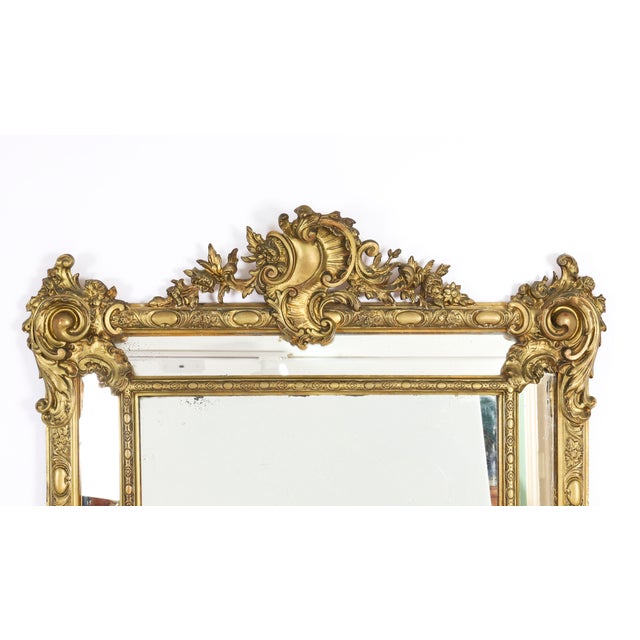 This is a magnificent antique French Louis Revival giltwood overmantle cushion mirror, circa 1860 in date. The central...