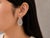 These designer French clip earrings are crafted in 18K white gold by Odelia and feature numerous brilliant round white...