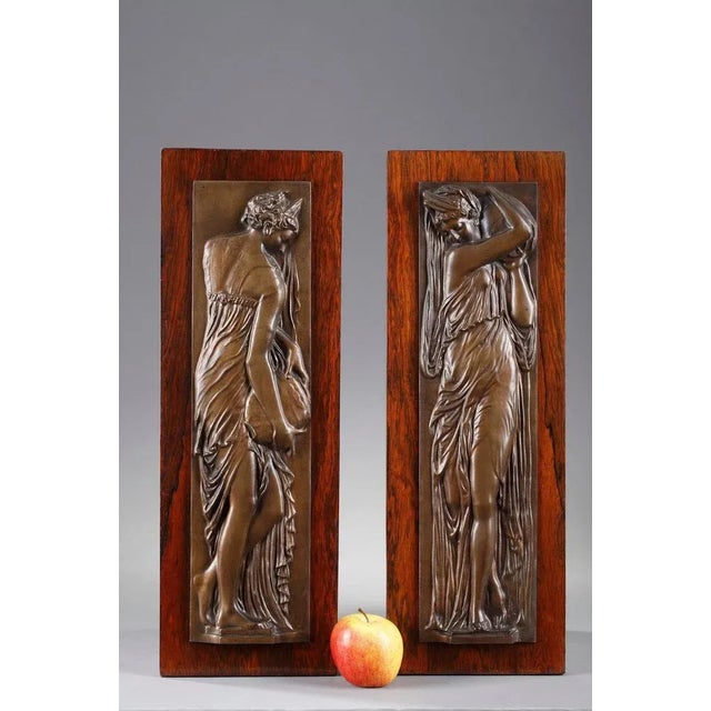 Pair of bronze bas-relief from the end of the 19th century, with brown patina, fixed on a wood veneer support,...