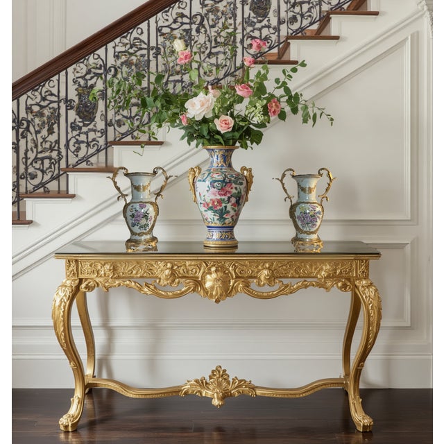 A matching pair of ornate decorative urns is shown, with elaborate ormolu-mounted detailing and finely painted porcelain...