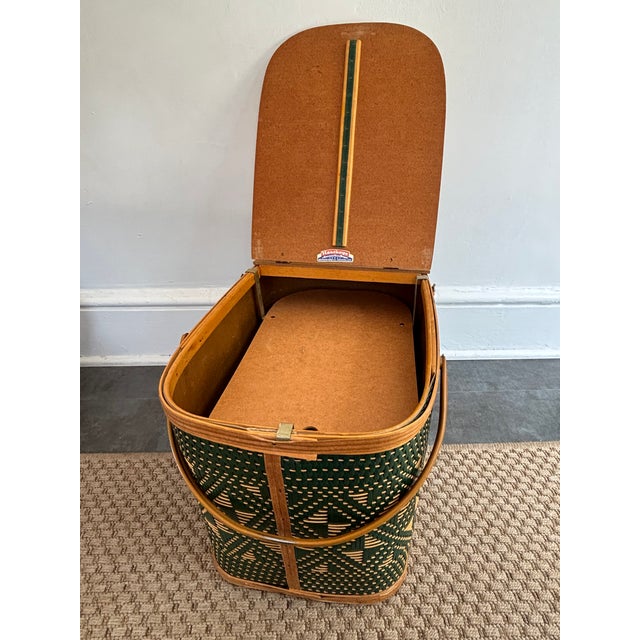 This mid century picnic hamper was made by the Burlington Basket Company of Burlington, Iowa. The sides are woven in a...