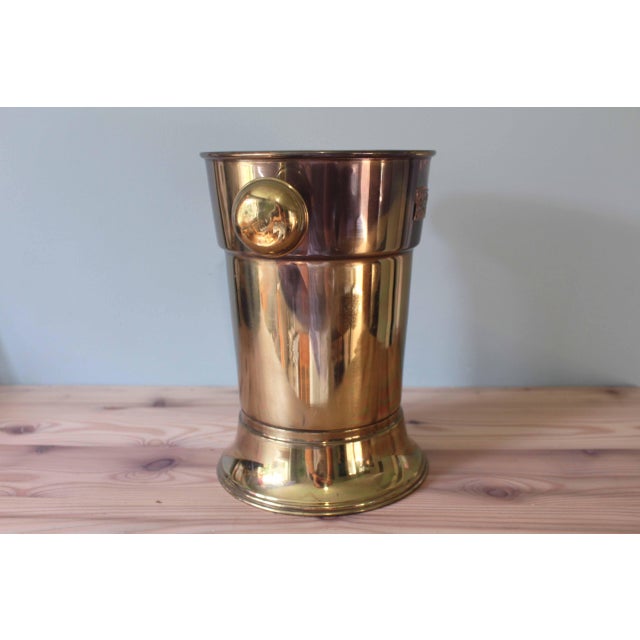 This vintage brass ice bucket embodies the timeless elegance of classic tableware. Its flared cylindrical silhouette is...