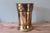 This vintage brass ice bucket embodies the timeless elegance of classic tableware. Its flared cylindrical silhouette is...