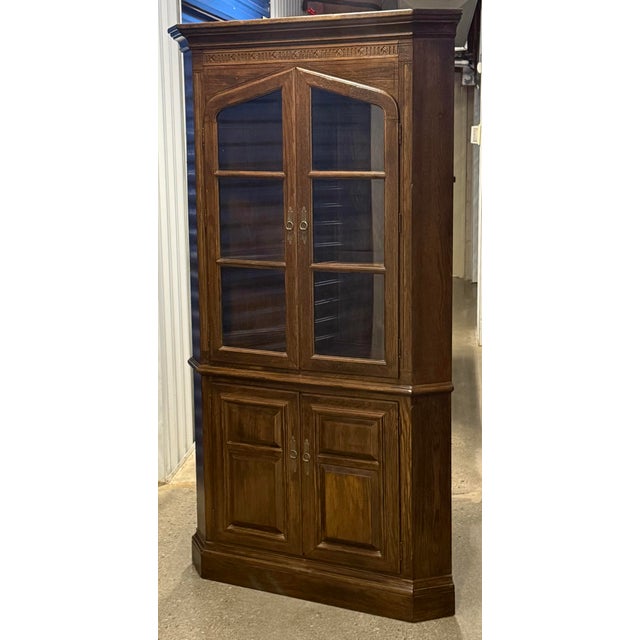 Classic Jacobean styled corner cabinet by Ethan Allen from their Royal Charter Oak Collection. Crafted in solid oak...