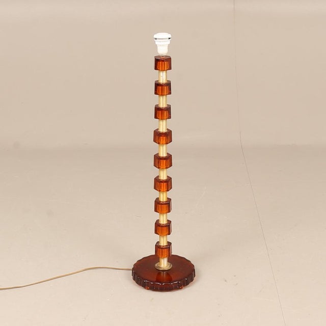 Table/Floor lamp from Sweden 1960s cast glass amber color and brass. Manufactured in Sweden 1960 by Nybro Armaturfabrik...