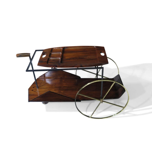 Jorge Zalszupin Carrinho de Chá bar cart crafted of Jacaranda Rosewood with solid brass wheels and carved removable tray....