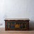 Painted pine blanket chest featuring a hand-painted church facade framed by floral urns and geometric borders, circa 1900....