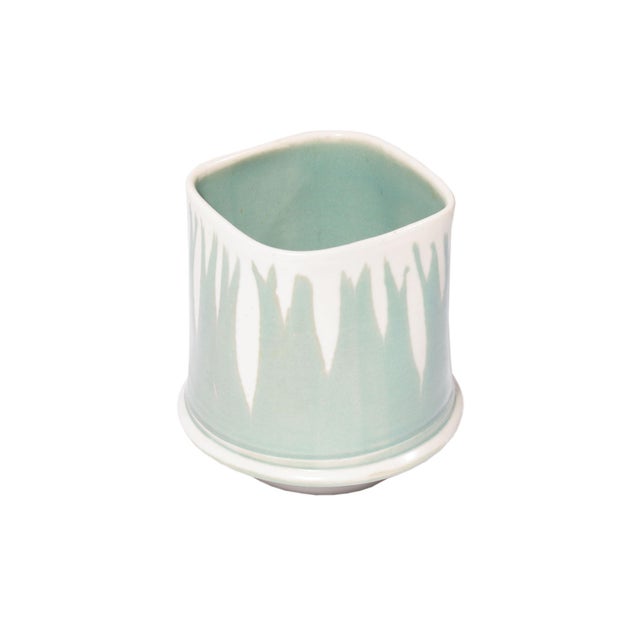 A 1992 studio pottery vase by the American ceramic artist Larry Pejeau. This vase features a square top rim and a round...