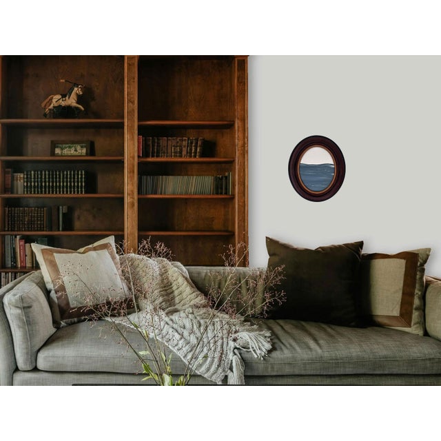 Step into a moment of stillness with "Porthole XIX” Housed in an intricately detailed antique frame, this piece evokes a...