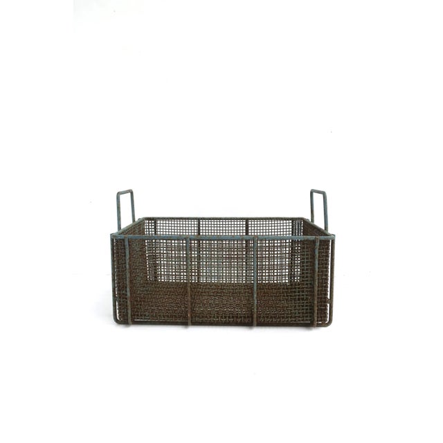 A substantial and well-made iron weaved basket with a blue-gray hue, circa mid-20th century or earlier. Basket is...
