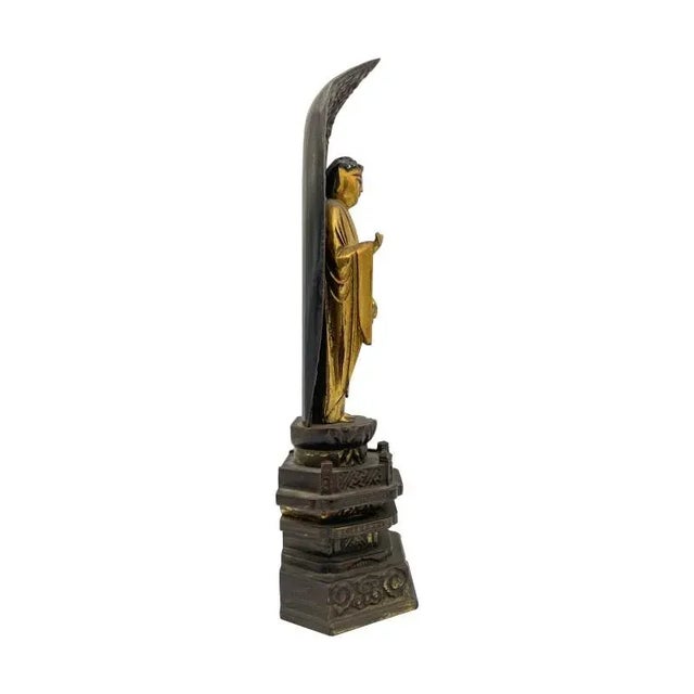 Standing figure of the Buddha from the Meiji period. On a lotus-form plinth above a stepped base. Haloed with a mandorla...