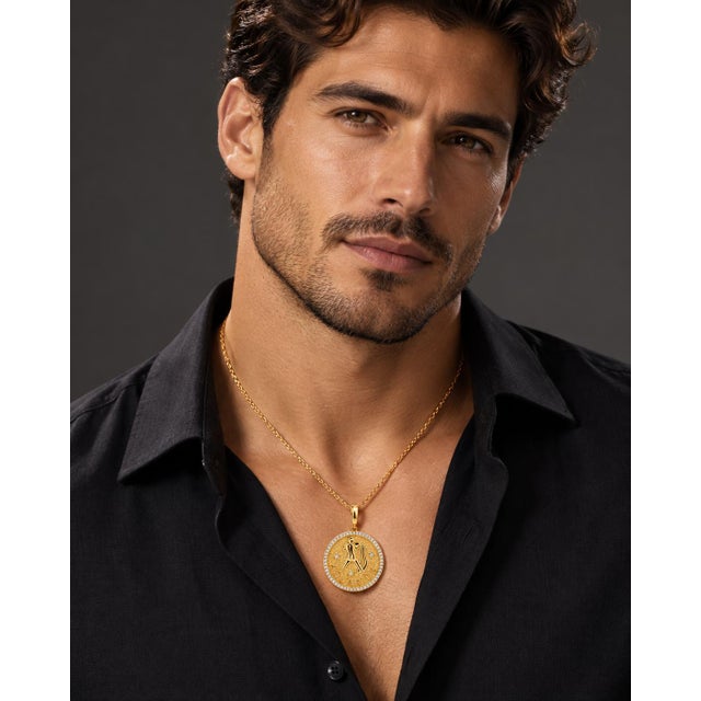 An authentic fine jewelry astrological statement pendant crafted in solid 14k yellow gold. Featuring a stylized Aquarius...