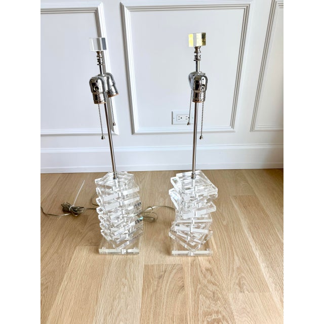 An exceptional, substantial pair of sculptural stacked lucite table lamps dating to the 1970s, distinguished by their...
