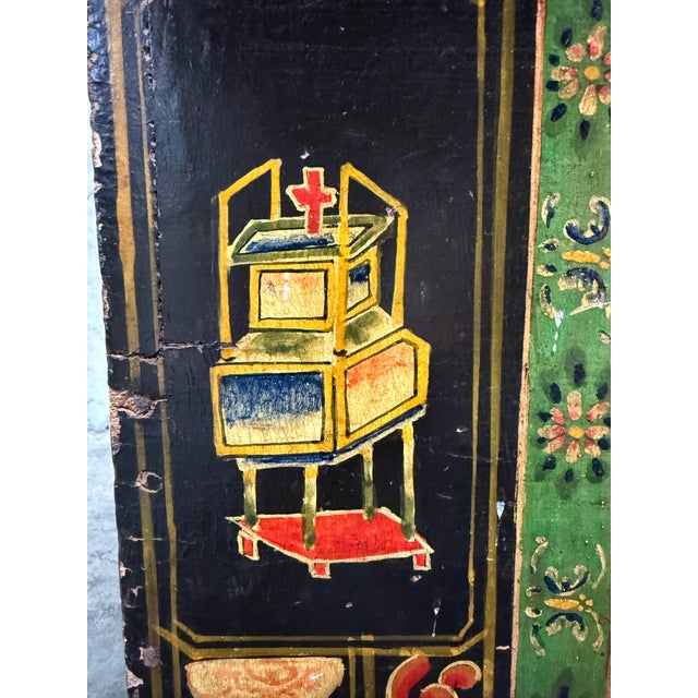 A striking early 20th century Chinese opera trunk, richly decorated with hand-painted scenes and symbolic motifs. The...