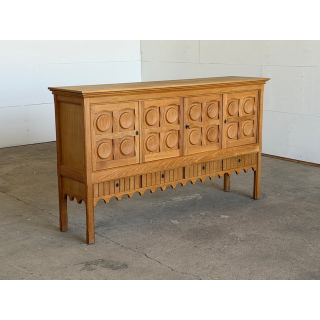 Danish oak brutalist sideboard credenza by Henning Kjærnulf for Nyrup Møbelfabrik, executed in solid oak with a warm,...