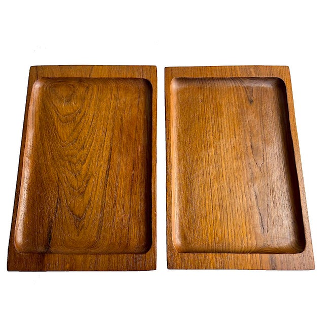 Offered is a pair of vintage hand carved teak wood trays. They feature curved and beveled sides, and recessed centers....