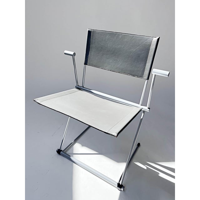 There are two grey and two teal coloured chairs available This piece has an attribution mark, I am sure that it is...