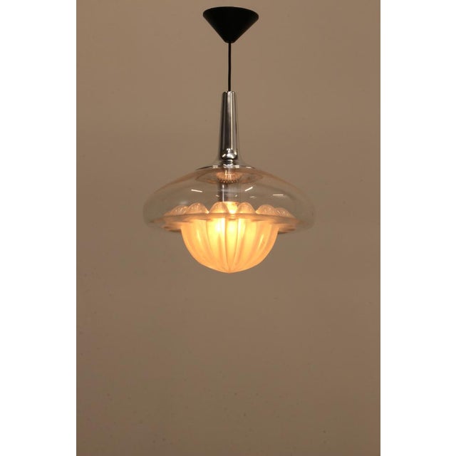 Beautiful mouth-blown glass pendant made by Peill & Putzler in the 1960s. This mid-century pendant looks a bit like a...