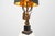 A Hollywood Regency table lamp by the Belgian maker Deknudt, crafted around 1980 and featuring a dramatic sculptural eagle...