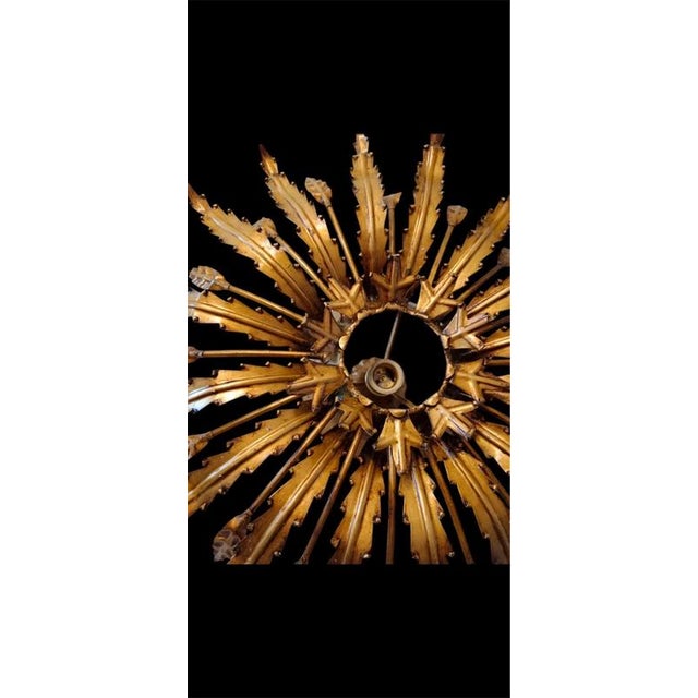 Midcentury antique gilt iron frame or pendant with laurel leaf motifs surrounding a central frosted glass diffuser....