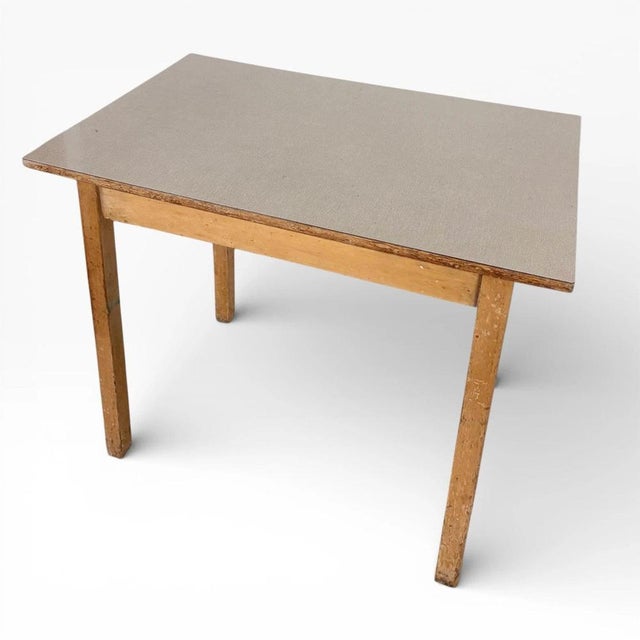 This mid century dining table features a vintage Formica table top in a stylish taupe laminate, paired with solid wooden...
