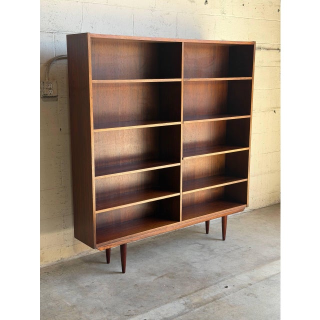 This grand open shelving unit features a clean double-column layout with a beautifully streamlined frame. The minimalist...