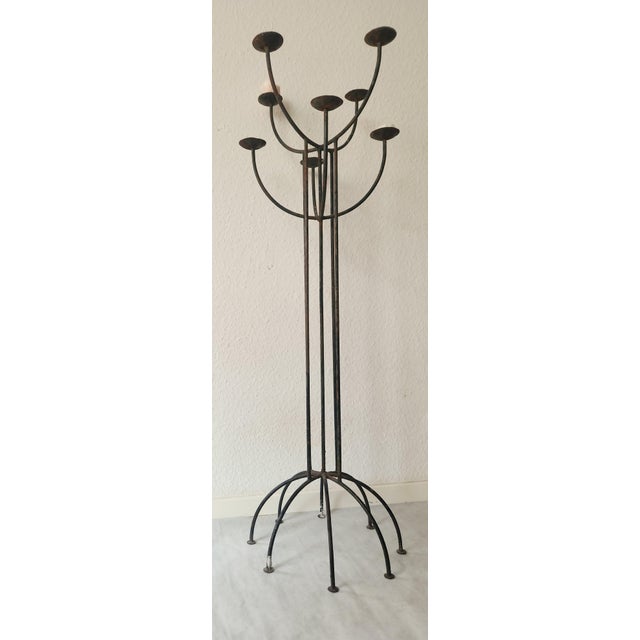 This impressive, sculptural, eight-armed wrought iron candlestick combines architectural clarity with expressive...