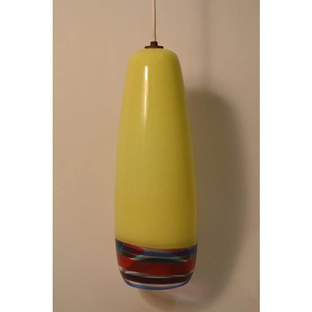 Venini sigaro pendant in lemon yellow with colored ban striped bottom, designed by Massimo Vignelli. Rare extra large...