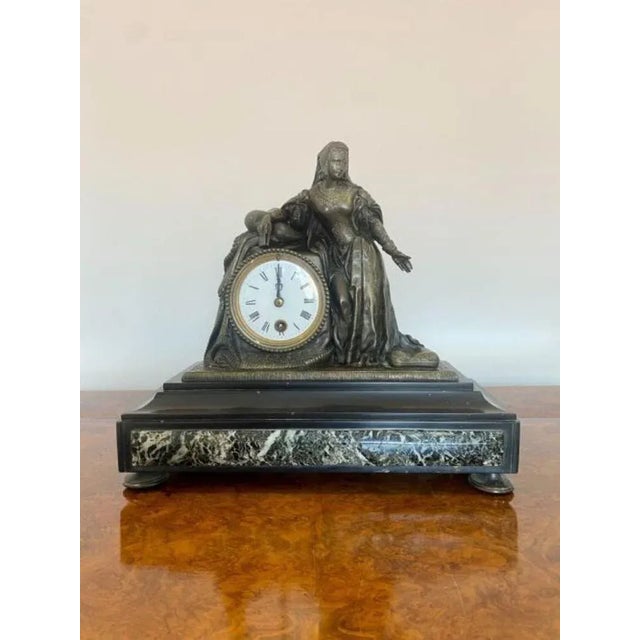 A quality Victorian Marble mantle clock with black Roman numerals with a white enamel face, the bronzed figural case...