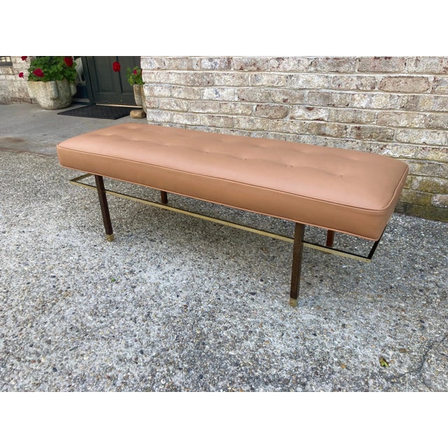 Harvey Probber brass and wood frame bench upholstered in camel colored leather... elegant brass sabots and stretcher........