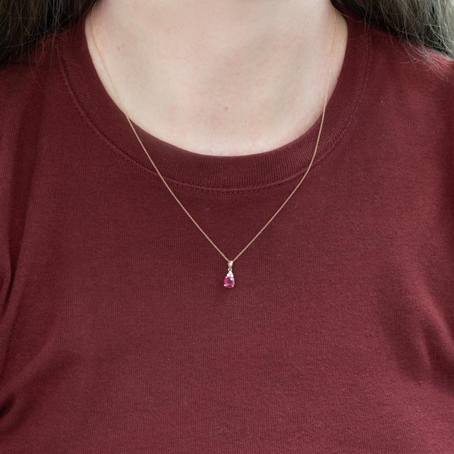 Elegant Madagascar Ruby Pendant featuring a vibrant round 4.5mm natural ruby, showcasing a rich, deep red hue that...