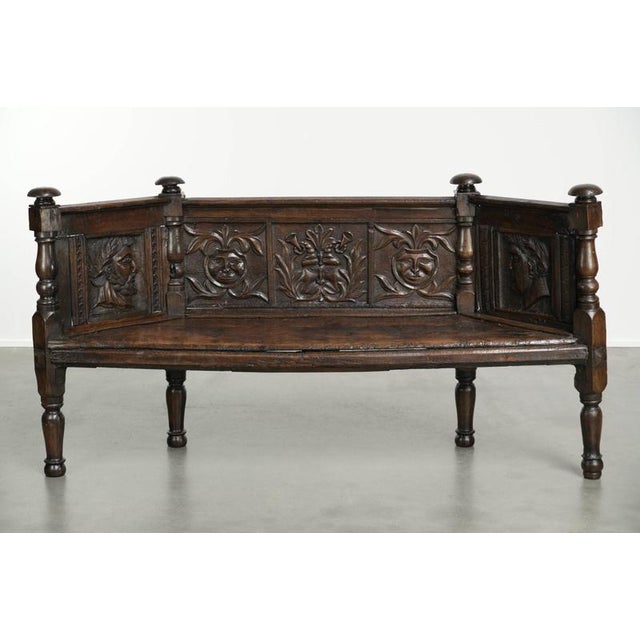 This unique and likely Italian entryway bench dates from the 17th and 18th centuries and features exquisite wood carvings...