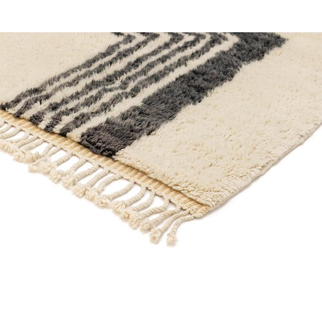Exquisite hand-knotted wool rug featuring a fusion of organic patterns, with an Ivory base, Misty Taupe animal print, and...