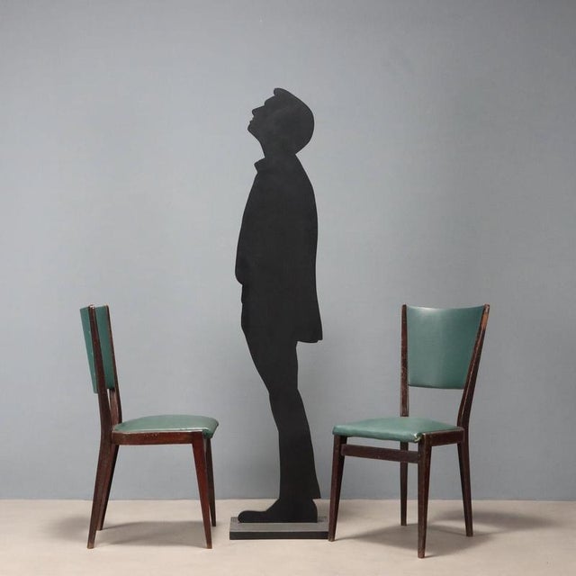 Set of 4 chairs with stained beech wood frame, foam padding and imitation leather upholstery. This piece is attributed to...