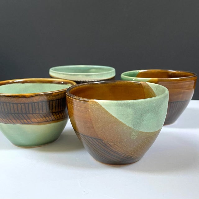 Handmade pottery bowls/cups each with a unique design and slightly different in size. Impeccable set of 4. Signed by the...