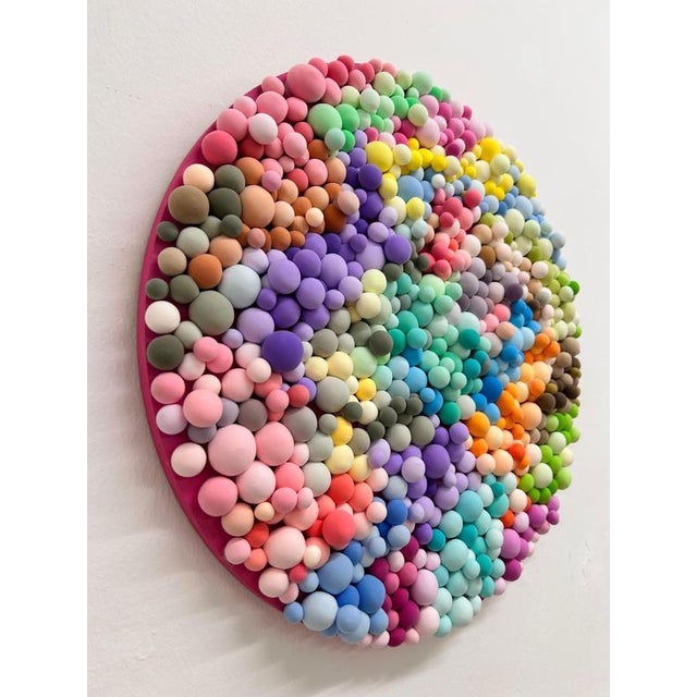 "Fake Gum" is a captivating circular wall sculpture by Elizabeth Art Candy that explores the seductive tension between...