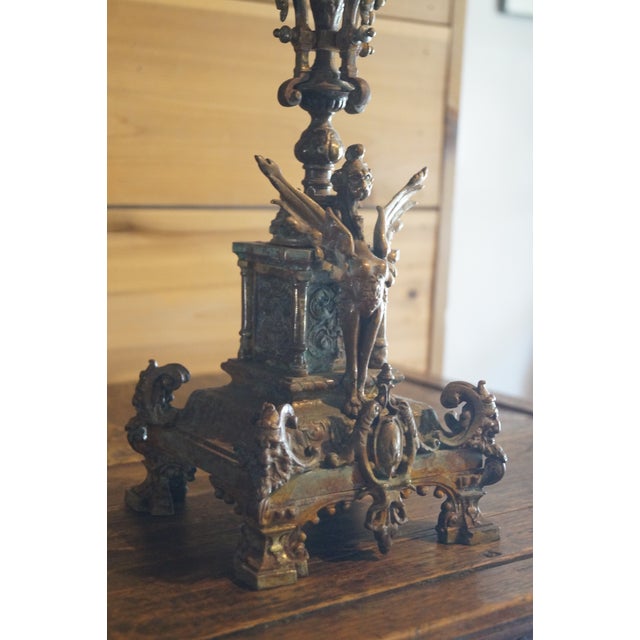 A striking and ornate bronze candelabra which is most likely French in origin. Three sided so that it may sit flush...
