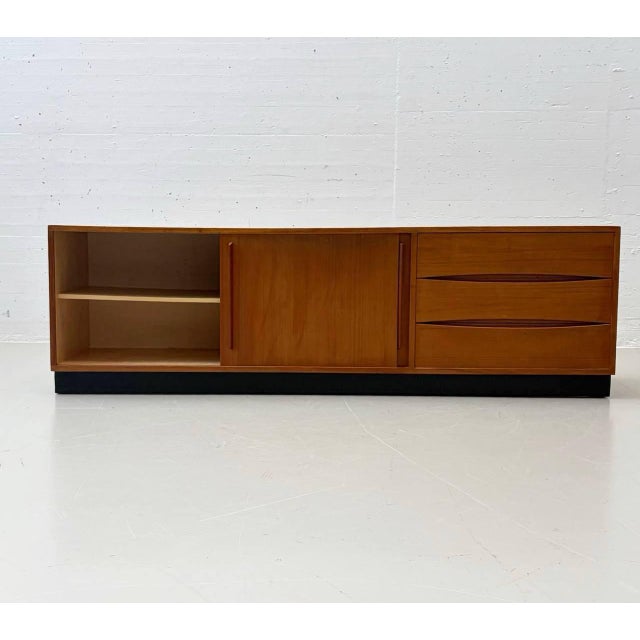 Elegant teak veneer sideboard designed by swiss designer dieter wäckerlin. Its clean, horizontally emphasized design...