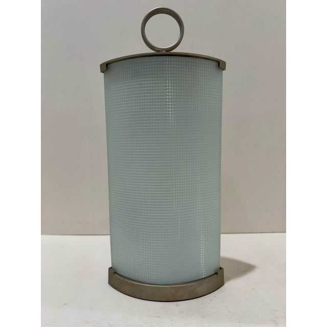 Authentic Fontana Arte Pirellina table lamp designed by Gio Ponti. Frosted textured curved glass with satin metal mounts...