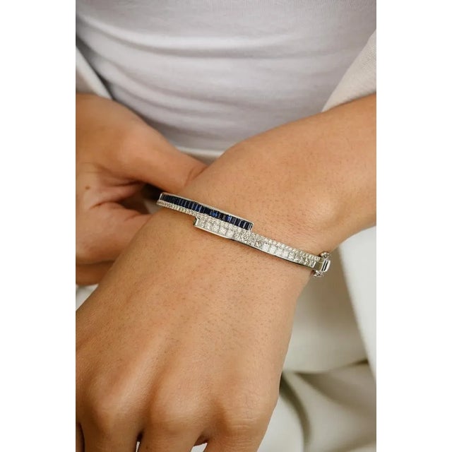 This is part of Chairish’s Fine Jewelry assortment. This Brilliant Diamond and Blue Sapphire Cuff Bracelet in 18K gold...