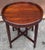 This Chinese Qing Style hardwood side table features a circular top with a distinctive raised lip and an intricately...
