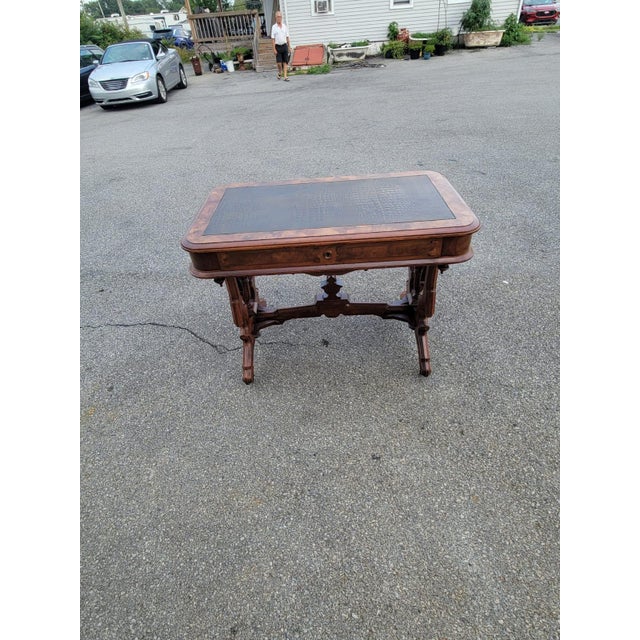 Beautiful 19th-century American Victorian parlor table crafted in richly figured walnut. Features a newly fitted leather...