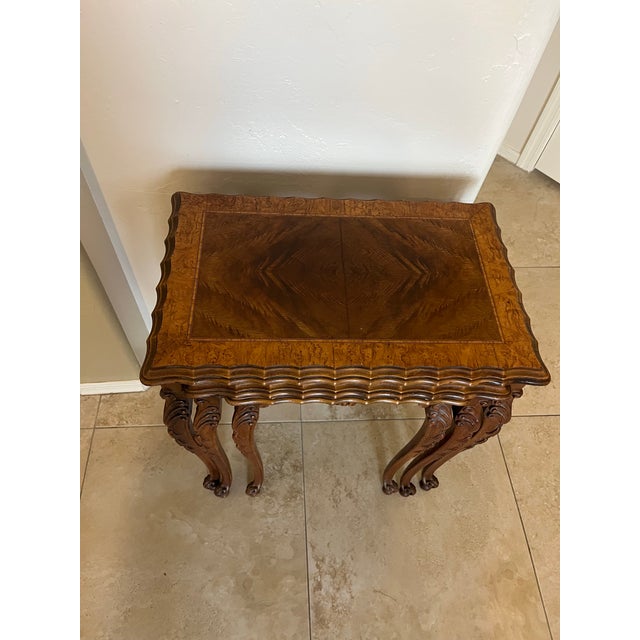 This is a set of three 1930s burr walnut nesting tables, potentially American-made from the 1930s. They are made of walnut...